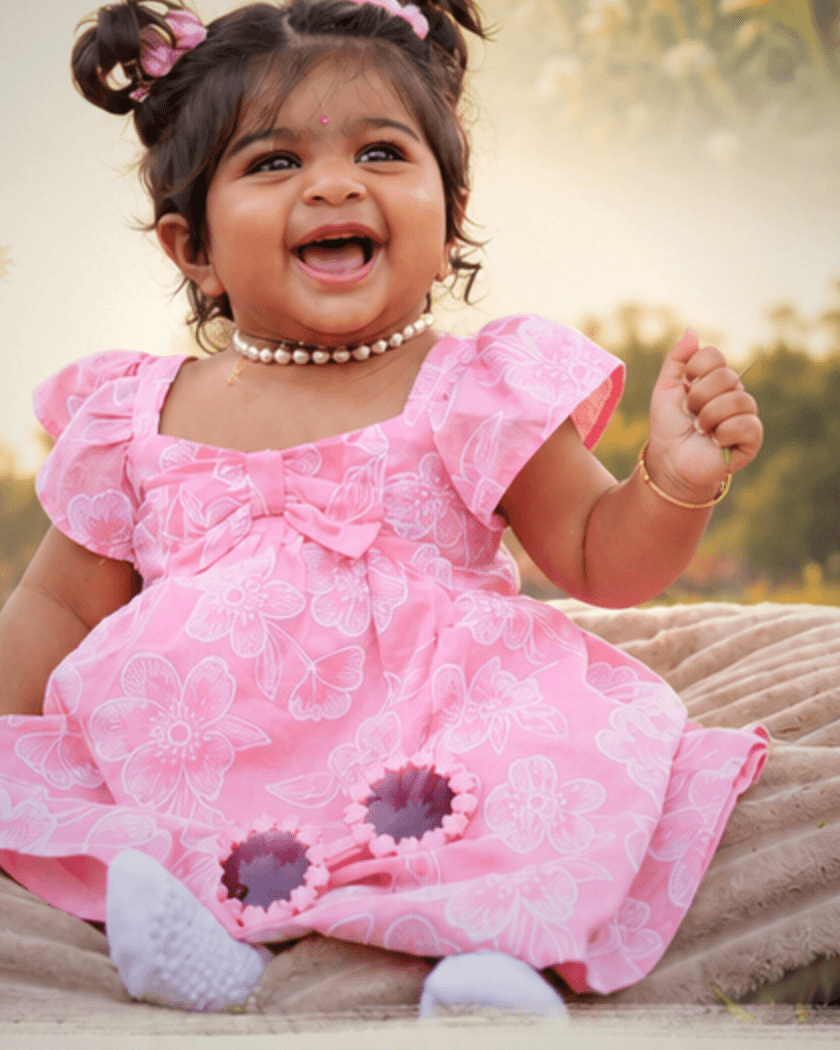 Maithili Tara, the founder's daughter, smiling in a pink outfit — the family milestone that inspired the trust